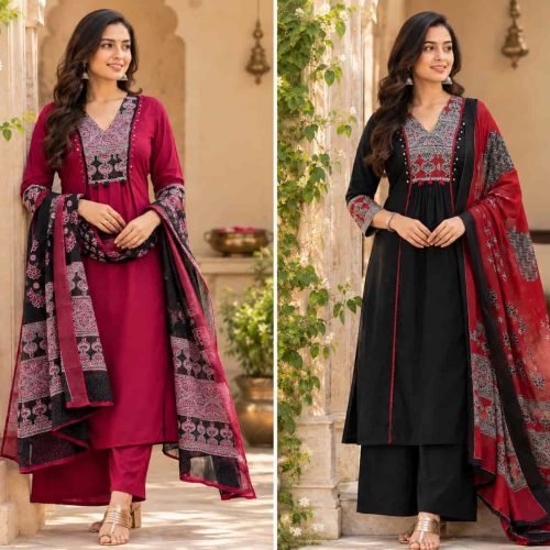 A woman modeling a black V-neck printed kurta set with dupatta featuring red accents and small tassels